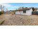 Large backyard with rock landscaping, rock drainage, and perimeter fencing at 2593 E Commonwealth Cir, Chandler, AZ 85225