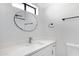 Modern bathroom features a vanity with countertop sink, round mirror and white paint at 2593 E Commonwealth Cir, Chandler, AZ 85225