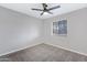 This bedroom features neutral carpet, paint, ceiling fan, and natural light from the window at 2593 E Commonwealth Cir, Chandler, AZ 85225