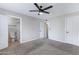 Spacious bedroom with an attached bathroom and closet with neutral carpet, paint, and ceiling fan at 2593 E Commonwealth Cir, Chandler, AZ 85225