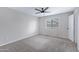 Spacious bedroom featuring neutral carpet, paint, ceiling fan, and natural light from window at 2593 E Commonwealth Cir, Chandler, AZ 85225