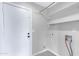 Well lit laundry room with white walls, tile flooring and storage shelves at 2593 E Commonwealth Cir, Chandler, AZ 85225