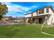 Expansive backyard with artificial turf, trampoline, playground, and a covered patio for outdoor living at 28422 N 32Nd Ln, Phoenix, AZ 85083