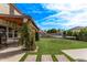 Beautiful backyard with artificial turf, trampoline, a covered patio and green landscaping at 28422 N 32Nd Ln, Phoenix, AZ 85083