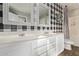 A well-lit bathroom with double sinks and black and white checkered wallpaper at 28422 N 32Nd Ln, Phoenix, AZ 85083