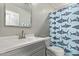 Clean bathroom features a white vanity, shark-themed shower curtain, modern sink, and a toilet at 28422 N 32Nd Ln, Phoenix, AZ 85083