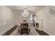 Formal dining room with decorative chandelier, wainscoting, fireplace and hardwood flooring at 28422 N 32Nd Ln, Phoenix, AZ 85083