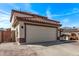 Side view of a two car garage with a well-manicured lawn in front of a charming home at 28422 N 32Nd Ln, Phoenix, AZ 85083