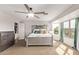 Bright main bedroom with a ceiling fan and a window with backyard views at 28422 N 32Nd Ln, Phoenix, AZ 85083