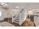 Elegant staircase with white railings and wood steps, open to the living area and kitchen at 28422 N 32Nd Ln, Phoenix, AZ 85083