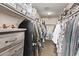 An organized walk-in closet with ample storage and custom shelving for clothing and accessories at 28422 N 32Nd Ln, Phoenix, AZ 85083
