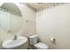 Cozy powder room featuring a pedestal sink, toilet, and floral wallpaper border at 3410 E Pageant Pl, Gilbert, AZ 85297