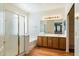 Primary bathroom with a glass-enclosed shower, soaking tub, dual vanities, and ample storage at 3410 E Pageant Pl, Gilbert, AZ 85297