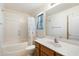 Bathroom featuring a tub/shower combination and wooden vanity at 3410 E Pageant Pl, Gilbert, AZ 85297