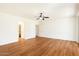 Spacious bedroom featuring wood-look floors, a ceiling fan, and a view of walk-in closet at 3410 E Pageant Pl, Gilbert, AZ 85297