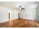 Large bedroom with wood floors, ceiling fan, bright natural light, and an adjacent walk-in closet at 3410 E Pageant Pl, Gilbert, AZ 85297