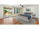 Bright bedroom with a sliding glass door to backyard, ceiling fan, and modern decor at 3410 E Pageant Pl, Gilbert, AZ 85297