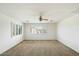 Spacious bedroom with a ceiling fan and multiple windows for abundant natural light at 3410 E Pageant Pl, Gilbert, AZ 85297