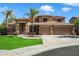 Charming two-story home with a well-manicured lawn, a three-car garage, and beautiful palm trees at 3410 E Pageant Pl, Gilbert, AZ 85297