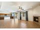 Spacious living room with fireplace, tile floors, natural light and seamless flow to the kitchen at 3410 E Pageant Pl, Gilbert, AZ 85297