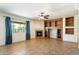 Inviting living room featuring a cozy fireplace, custom built-ins, and a view to the backyard at 3410 E Pageant Pl, Gilbert, AZ 85297