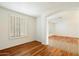 Bright living room with wood floors, white walls, and shuttered windows creating an open space at 3410 E Pageant Pl, Gilbert, AZ 85297