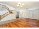 Open-concept living area with wood floors, staircase, chandelier, and ample natural light at 3410 E Pageant Pl, Gilbert, AZ 85297