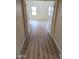 Inviting hallway leading to bedrooms with new wood floors and natural light at 36452 W Velazquez Dr, Maricopa, AZ 85138