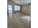 Open-concept living room with stylish wood floors and natural light at 36452 W Velazquez Dr, Maricopa, AZ 85138
