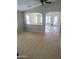 Cozy living room with arched entryway, tile flooring and lots of natural light at 36452 W Velazquez Dr, Maricopa, AZ 85138