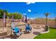 Relaxing backyard area with Adirondack chairs and a custom fire pit at 3687 E Blue Spruce Ln, Gilbert, AZ 85298