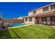 Relax in this home's inviting backyard oasis with pool, covered patio and low maintenance turf at 3687 E Blue Spruce Ln, Gilbert, AZ 85298