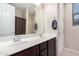 This bathroom features double sinks, dark cabinetry, and tile floors at 3687 E Blue Spruce Ln, Gilbert, AZ 85298