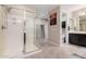 Bright bathroom with glass-enclosed shower, neutral tile flooring and dark wood cabinets at 3687 E Blue Spruce Ln, Gilbert, AZ 85298
