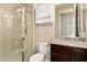 Bathroom featuring a walk-in shower, vanity with granite countertop, and storage cabinet at 3687 E Blue Spruce Ln, Gilbert, AZ 85298