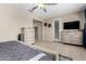 Spacious bedroom features a ceiling fan, dresser, and outdoor access at 3687 E Blue Spruce Ln, Gilbert, AZ 85298