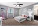 Bright bedroom with ceiling fan, and neutral colored walls at 3687 E Blue Spruce Ln, Gilbert, AZ 85298