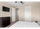 This bedroom features a TV, a ceiling fan, and neutral color walls at 3687 E Blue Spruce Ln, Gilbert, AZ 85298