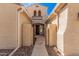 Exterior shot of the home's passageway featuring upgraded pavers and a wrought-iron security gate at 3687 E Blue Spruce Ln, Gilbert, AZ 85298