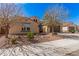 A desert home showcasing desert landscaping, a two-car garage, and a charming entry gate at 3687 E Blue Spruce Ln, Gilbert, AZ 85298