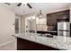 This kitchen features granite countertops, stainless steel appliances and view into other rooms at 3687 E Blue Spruce Ln, Gilbert, AZ 85298