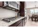 This kitchen showcases stainless steel appliances, granite countertops, and adjacent dining area at 3687 E Blue Spruce Ln, Gilbert, AZ 85298