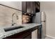 Close-up of kitchen sink and countertops with stainless steel appliances and tile backsplash at 3687 E Blue Spruce Ln, Gilbert, AZ 85298