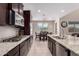 Modern kitchen features granite countertops, stainless steel appliances, and a view into the dining area at 3687 E Blue Spruce Ln, Gilbert, AZ 85298