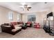 Comfortable living room with plush seating, natural light, and ceiling fan at 3687 E Blue Spruce Ln, Gilbert, AZ 85298