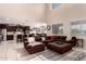 Open-concept living room with high ceilings, tile flooring, and seamless flow into the modern kitchen and dining area at 3687 E Blue Spruce Ln, Gilbert, AZ 85298