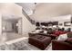 Spacious open-concept living room flowing into a modern kitchen, complete with a staircase and tile flooring at 3687 E Blue Spruce Ln, Gilbert, AZ 85298