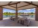 Community lakeside pavilion with picnic tables offers a beautiful shaded space for outdoor relaxation and activities at 3687 E Blue Spruce Ln, Gilbert, AZ 85298