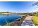 Scenic pond view with paved trail and landscaping in a community park setting at 3687 E Blue Spruce Ln, Gilbert, AZ 85298