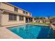 Inviting pool area offers cool relief with desert landscaping in this two-story home backyard at 3687 E Blue Spruce Ln, Gilbert, AZ 85298